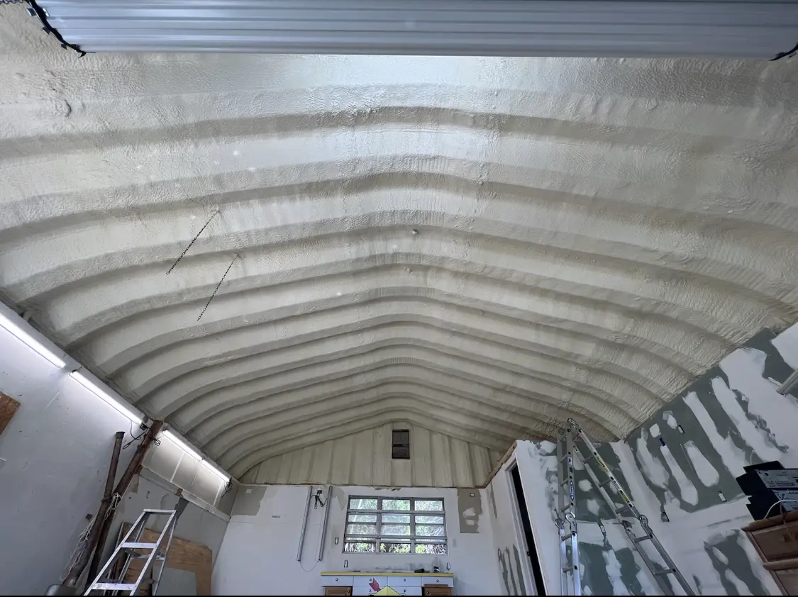 Spray polyurethane foam applied to the underside of a metal roof deck in Merrimac